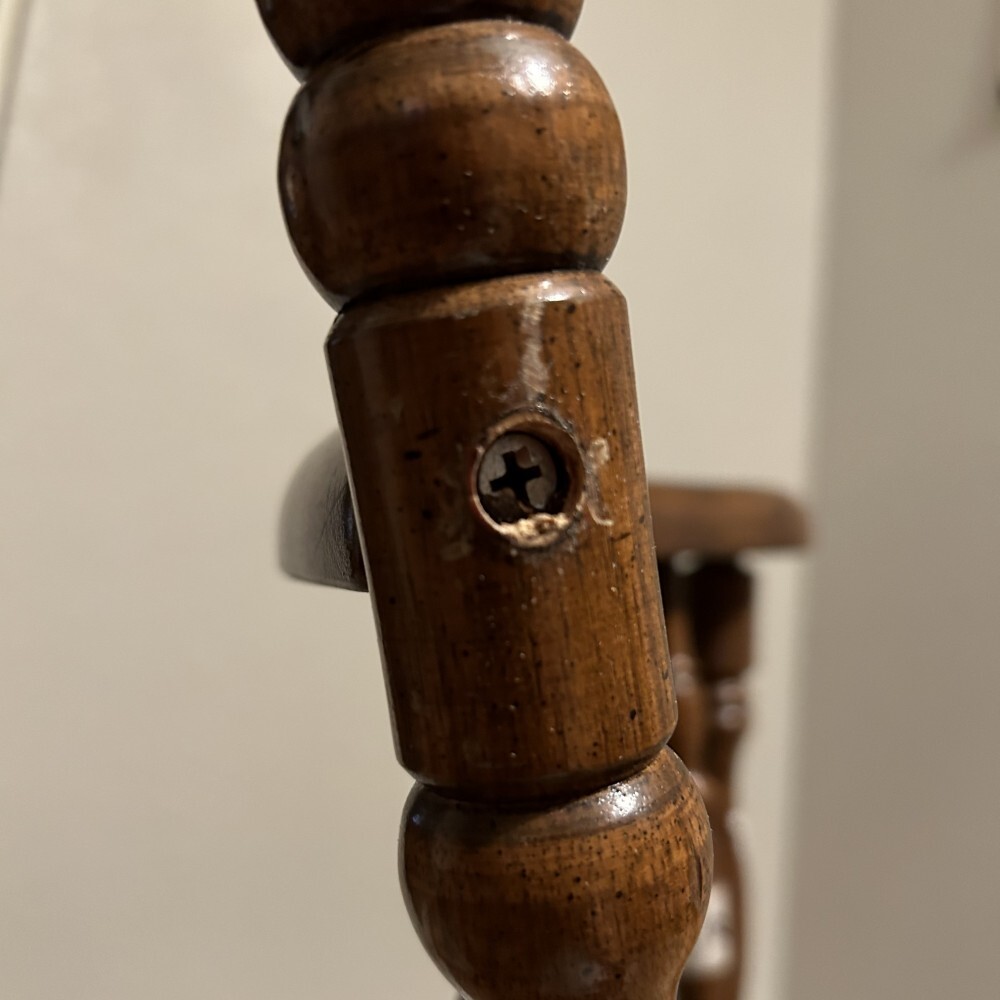 a close-up image of a phillips head screw fastening two members together